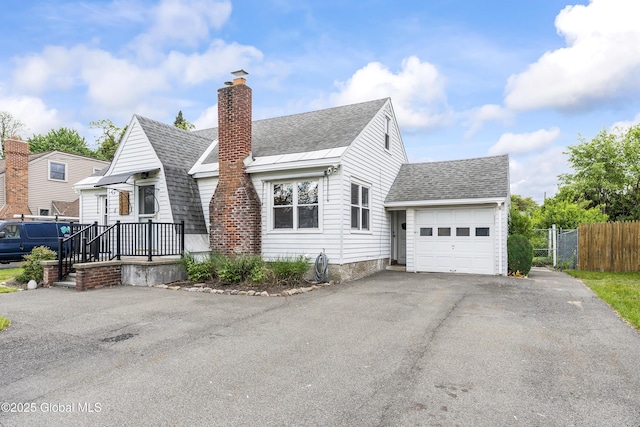 2044 Caldicott Rd, Rotterdam, NY 12303 - view of front of house with a shingled roof, asphalt driveway, a garage, and a chimney