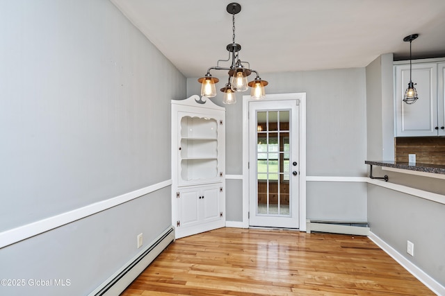 2044 Caldicott Rd, Rotterdam, NY 12303 - unfurnished dining area featuring a baseboard heating unit, a chandelier, and light wood-type flooring