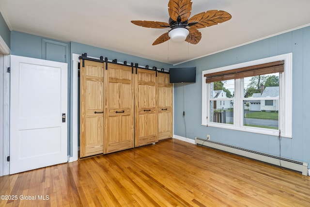 2044 Caldicott Rd, Rotterdam, NY 12303 - unfurnished bedroom with a baseboard radiator, light wood-style flooring, a barn door, and ceiling fan