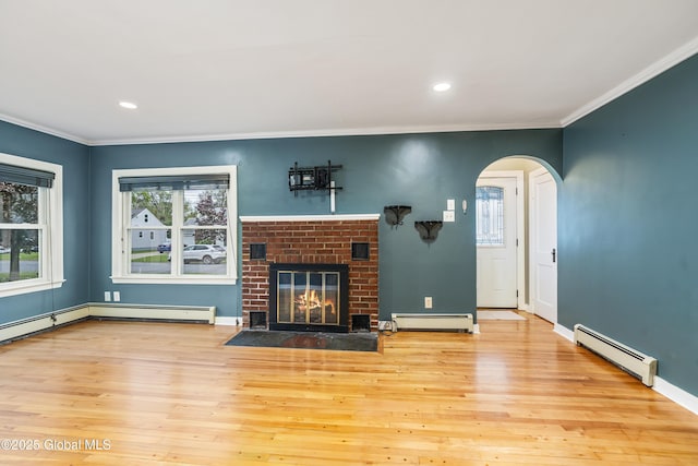 2044 Caldicott Rd, Rotterdam, NY 12303 - unfurnished living room featuring a baseboard radiator, arched walkways, crown molding, healthy amount of natural light, and recessed lighting