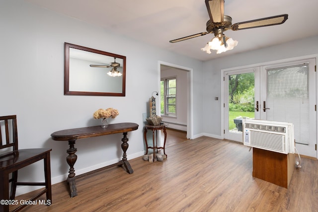 184 Main St, South Glens Falls, NY 12803 - foyer entrance featuring ceiling fan, a wall mounted air conditioner, baseboards, wood finished floors, and baseboard heating