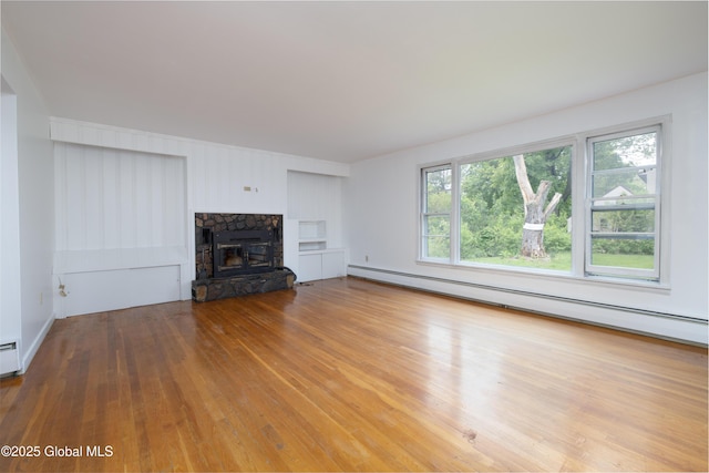 184 Main St, South Glens Falls, NY 12803 - unfurnished living room featuring a baseboard heating unit, wood finished floors, and a fireplace