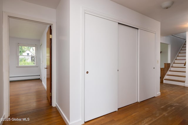 184 Main St, South Glens Falls, NY 12803 - hall with baseboard heating, wood finished floors, and stairway