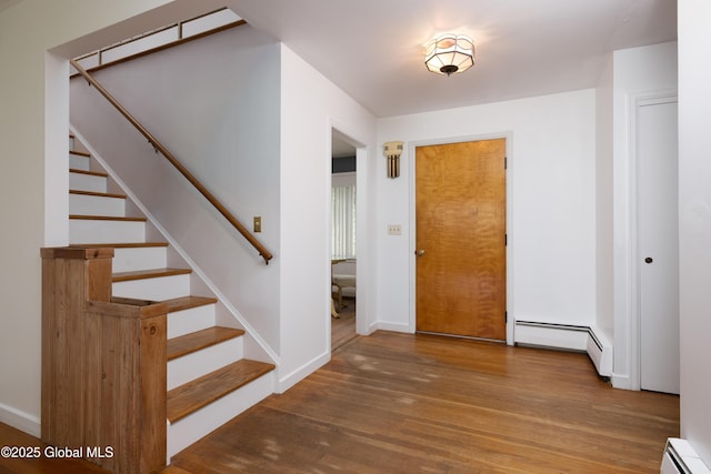 184 Main St, South Glens Falls, NY 12803 - entrance foyer with a baseboard radiator, wood finished floors, stairs, and baseboards