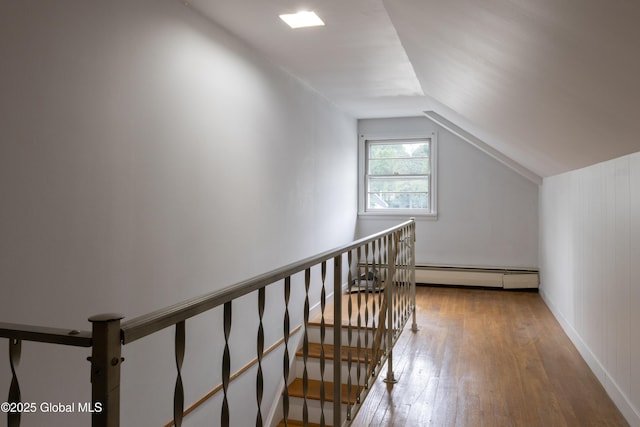 184 Main St, South Glens Falls, NY 12803 - stairs featuring a baseboard heating unit, hardwood / wood-style floors, and vaulted ceiling