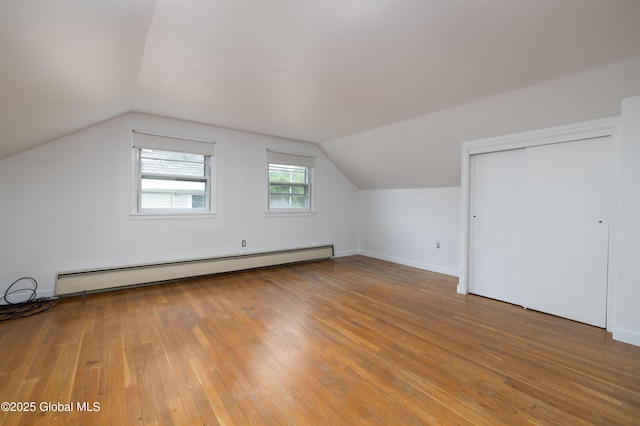 184 Main St, South Glens Falls, NY 12803 - bonus room featuring a baseboard heating unit, hardwood / wood-style flooring, vaulted ceiling, and baseboards