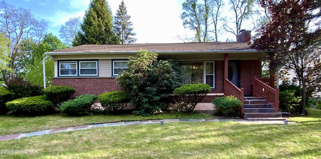 6 Kenyon Dr, Colonie, NY 12205 - view of front facade with brick siding, a chimney, and a front lawn