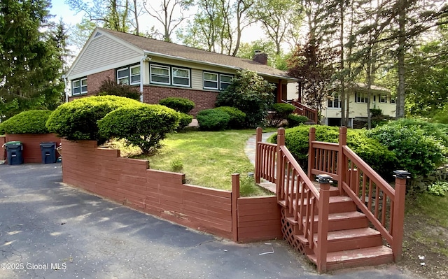 6 Kenyon Dr, Colonie, NY 12205 - view of front of house featuring brick siding, a chimney, and a front yard