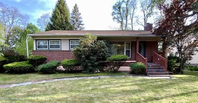 6 Kenyon Dr, Colonie, NY 12205 - view of front of house featuring brick siding, a chimney, a front yard, and a porch