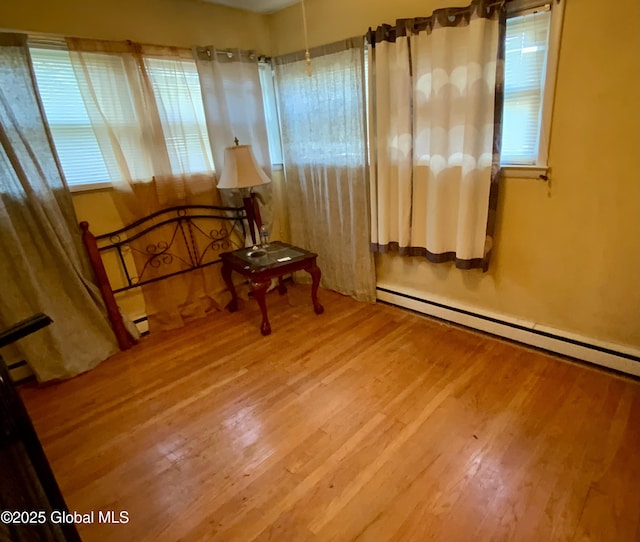 6 Kenyon Dr, Colonie, NY 12205 - living area with wood finished floors, plenty of natural light, and a baseboard radiator