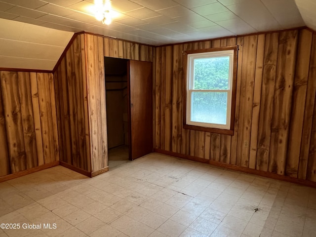 3778 County Rte 21, Whitehall, NY 12887 - unfurnished bedroom with light flooring, wood walls, a closet, and baseboards