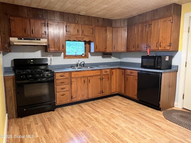 3778 County Rte 21, Whitehall, NY 12887 - kitchen featuring black appliances, under cabinet range hood, a sink, and light wood-style flooring