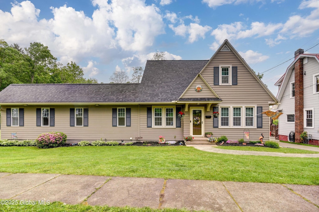 45 3rd St, Canajoharie, NY 13317 - view of front of house featuring a front lawn and a shingled roof