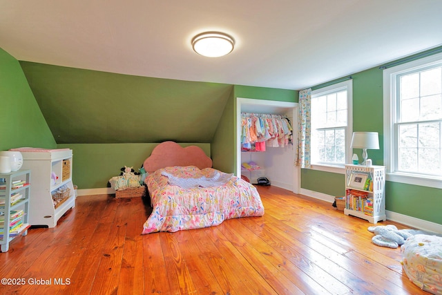 773 Charlton Rd, Charlton, NY 12019 - bedroom featuring multiple windows, wood-type flooring, and vaulted ceiling