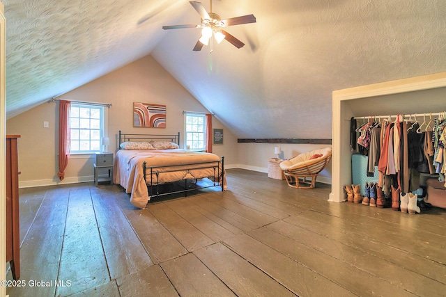 773 Charlton Rd, Charlton, NY 12019 - bedroom with wood-type flooring, lofted ceiling, multiple windows, a closet, and a textured ceiling