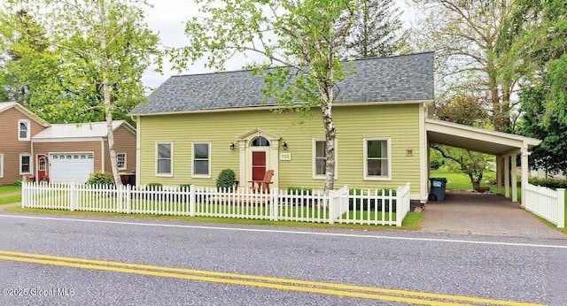 773 Charlton Rd, Charlton, NY 12019 - cape cod house with a fenced front yard, a carport, a garage, and a shingled roof
