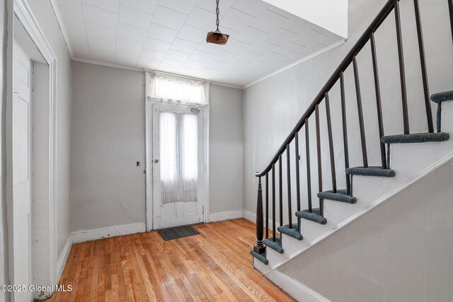 2127 2nd Ave, Watervliet, NY 12189 - entryway featuring crown molding, stairway, hardwood / wood-style flooring, and baseboards