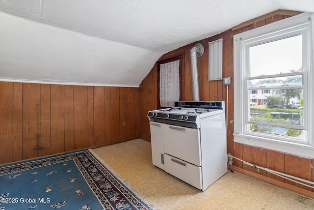 2127 2nd Ave, Watervliet, NY 12189 - kitchen with gas range gas stove, lofted ceiling, light flooring, and wood walls