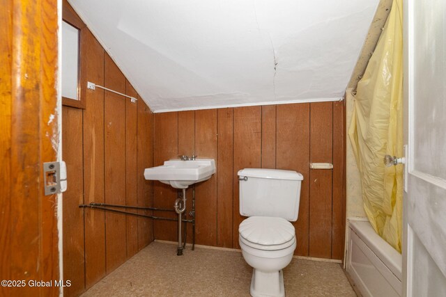 2127 2nd Ave, Watervliet, NY 12189 - full bathroom featuring toilet, wooden walls, lofted ceiling, and shower / tub combo