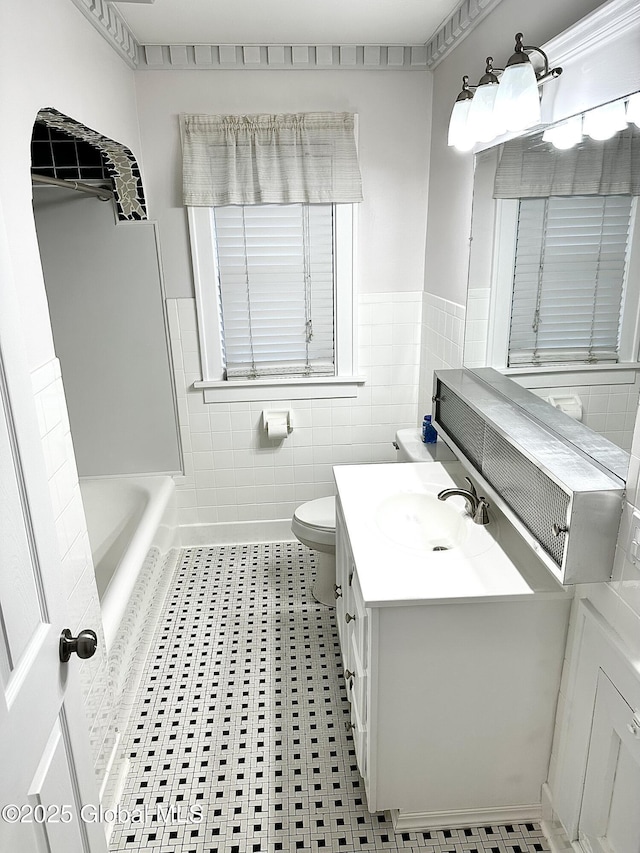 2618 Stanton St, Rotterdam, NY 12306 - full bathroom with toilet, wainscoting, vanity, a bath, and tile patterned floors
