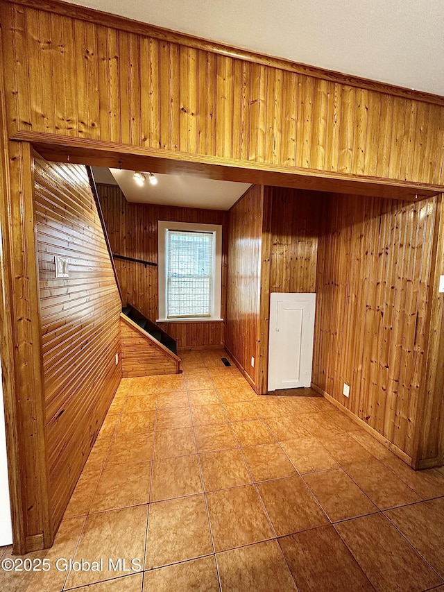 2618 Stanton St, Rotterdam, NY 12306 - empty room featuring wooden walls, light tile patterned flooring, and baseboards