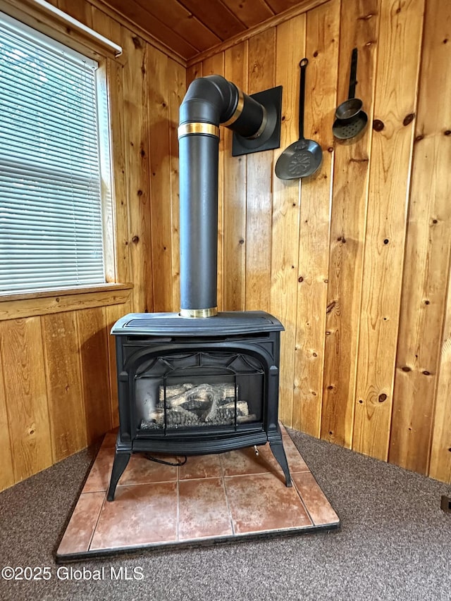 2618 Stanton St, Rotterdam, NY 12306 - detailed view of a wood stove, wood walls, carpet flooring, and wooden ceiling