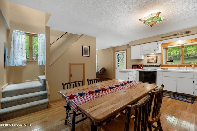 38 N Island Rd, Bolton, NY 12814 - dining room with stairway, light wood-style flooring, and a textured ceiling