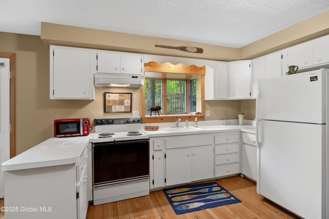 38 N Island Rd, Bolton, NY 12814 - kitchen featuring white appliances, under cabinet range hood, a sink, light wood finished floors, and a textured ceiling