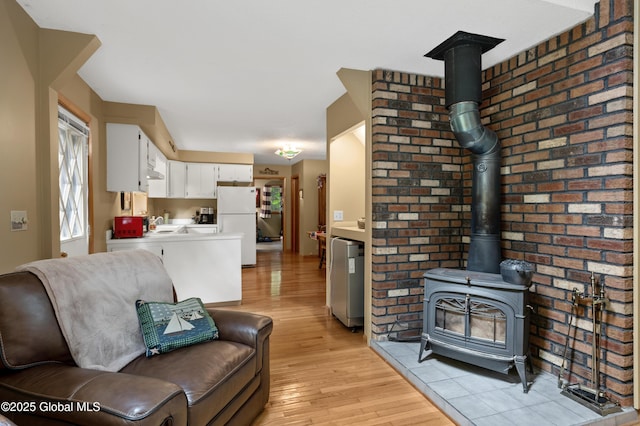 38 N Island Rd, Bolton, NY 12814 - living area with light wood-style floors, a wood stove, and brick wall
