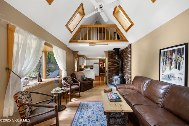 38 N Island Rd, Bolton, NY 12814 - living area with high vaulted ceiling, a wood stove, light wood-type flooring, and a ceiling fan