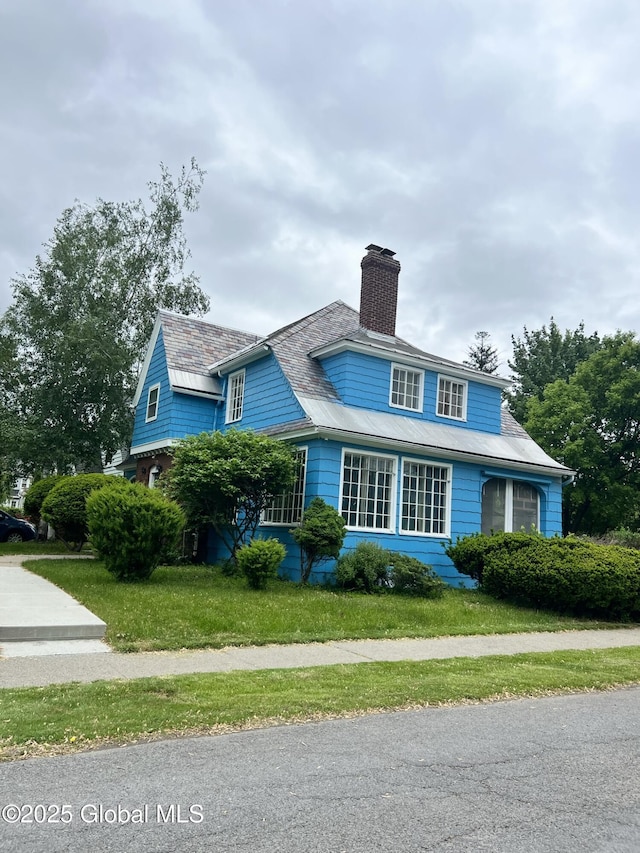 194 S Main Ave, Albany, NY 12208 - view of front of home with a chimney, a high end roof, and a front lawn