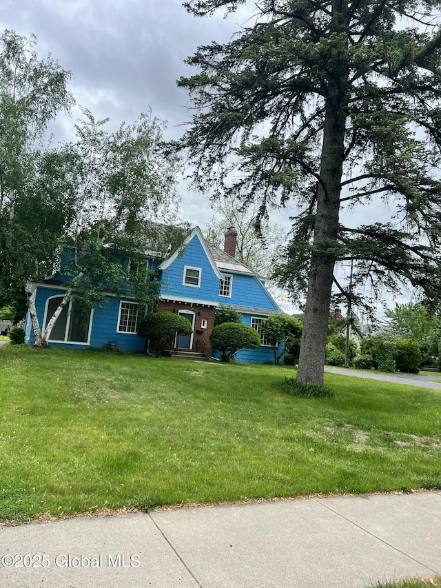 194 S Main Ave, Albany, NY 12208 - view of front facade with a chimney and a front yard