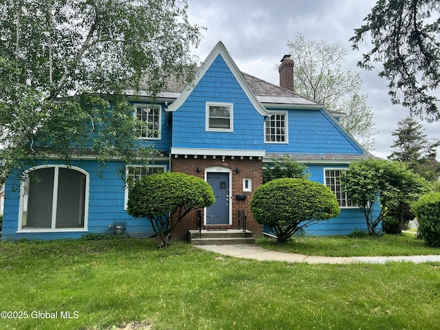 194 S Main Ave, Albany, NY 12208 - view of front of property with entry steps, a chimney, a front yard, and brick siding