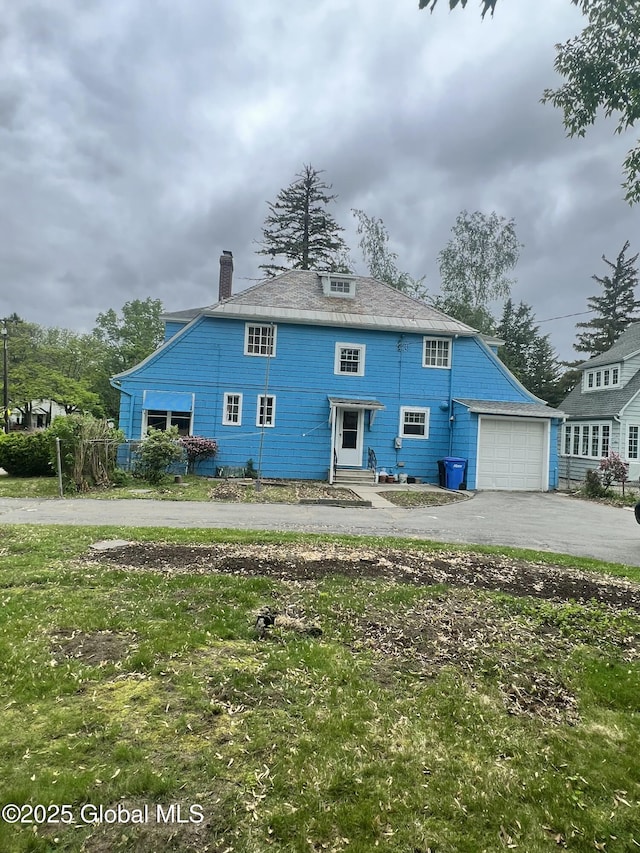 194 S Main Ave, Albany, NY 12208 - back of property with driveway, an attached garage, and a chimney