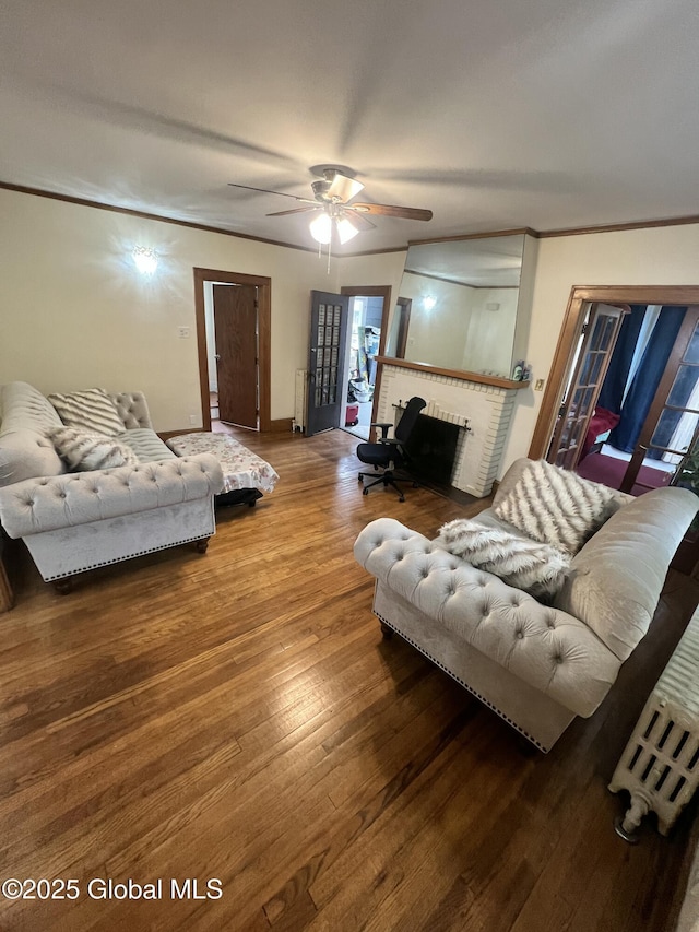 194 S Main Ave, Albany, NY 12208 - living area with wood finished floors, ceiling fan, a fireplace, baseboards, and ornamental molding