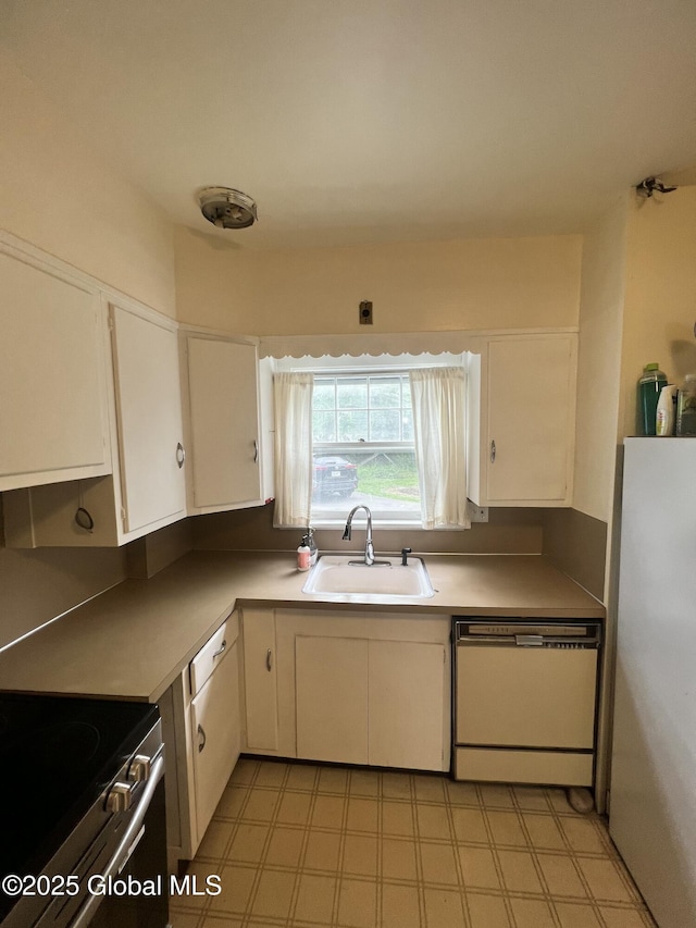 194 S Main Ave, Albany, NY 12208 - kitchen with appliances with stainless steel finishes, a sink, white cabinets, light flooring, and light countertops