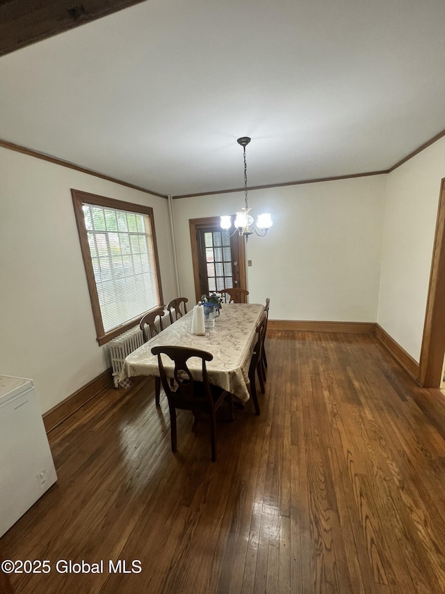 194 S Main Ave, Albany, NY 12208 - dining area featuring crown molding, dark wood-style floors, baseboards, and a chandelier