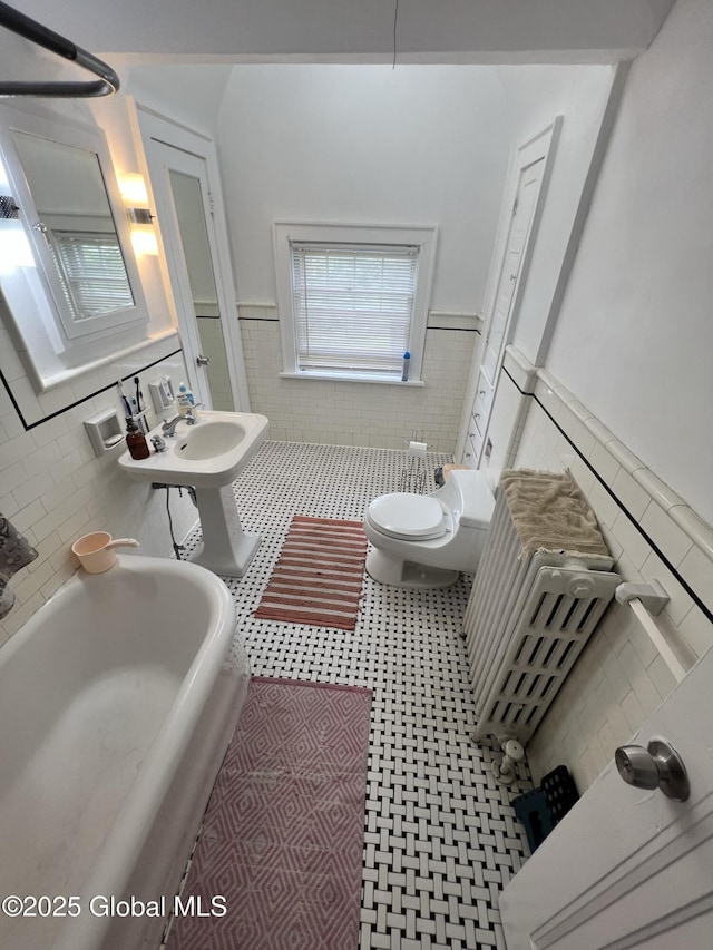 194 S Main Ave, Albany, NY 12208 - full bath featuring tile walls, wainscoting, toilet, and a sink