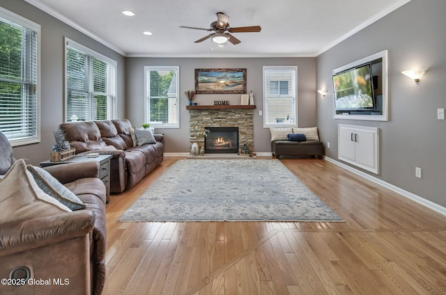 6 Copenhagen Ct, Colonie, NY 12047 - living room featuring a ceiling fan, baseboards, a stone fireplace, ornamental molding, and light wood-style flooring