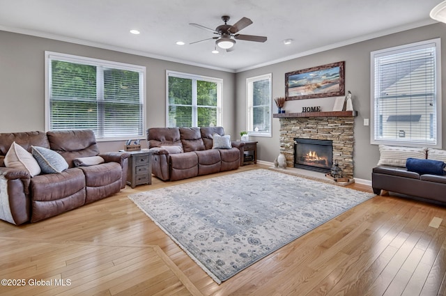 6 Copenhagen Ct, Colonie, NY 12047 - living area featuring ornamental molding, ceiling fan, a stone fireplace, light wood-style flooring, and recessed lighting