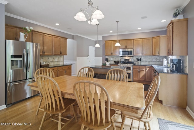 6 Copenhagen Ct, Colonie, NY 12047 - dining space with a chandelier, light wood-style flooring, ornamental molding, recessed lighting, and a wainscoted wall