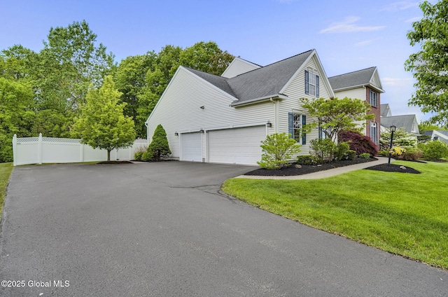 6 Copenhagen Ct, Colonie, NY 12047 - view of home's exterior featuring a garage, asphalt driveway, and roof with shingles