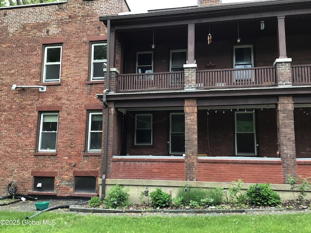 281 10th St, Troy, NY 12180 - back of house with a balcony and brick siding