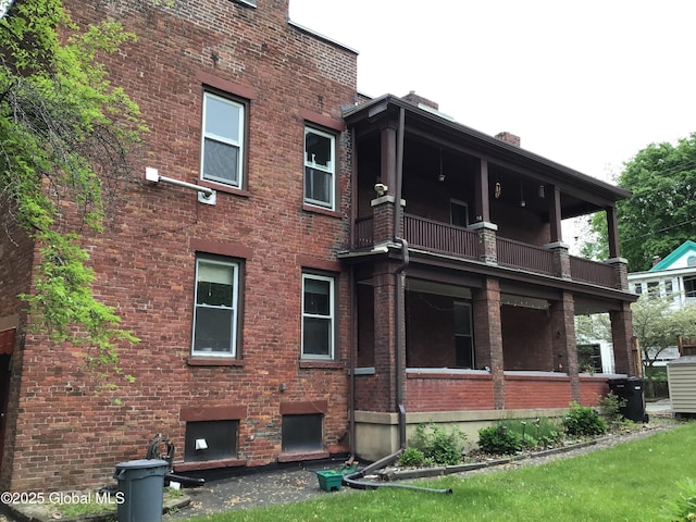 281 10th St, Troy, NY 12180 - back of house with a balcony and brick siding