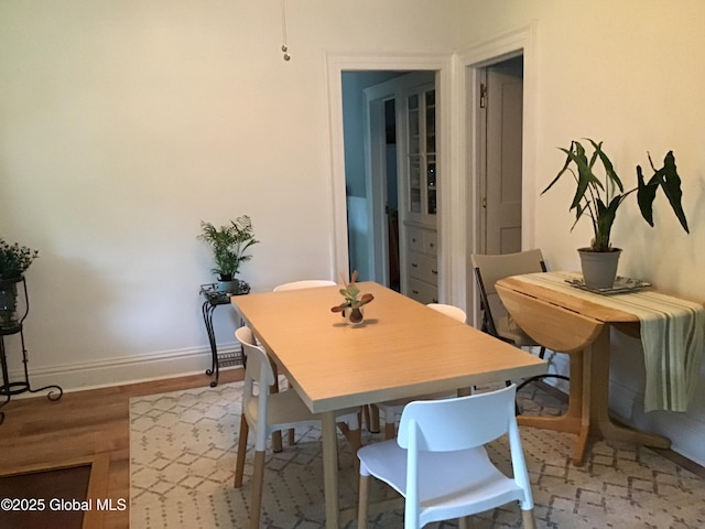281 10th St, Troy, NY 12180 - dining room featuring baseboards and light wood-style flooring