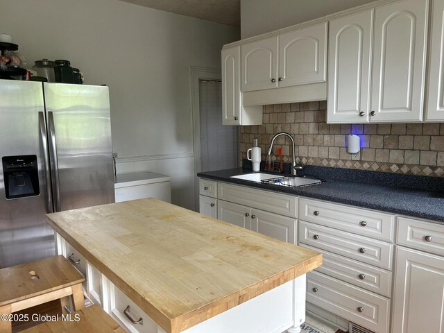 281 10th St, Troy, NY 12180 - kitchen featuring stainless steel refrigerator with ice dispenser, wooden counters, a sink, and white cabinets