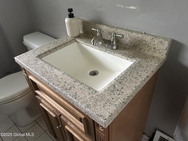 281 10th St, Troy, NY 12180 - half bathroom featuring toilet, vanity, and tile patterned floors