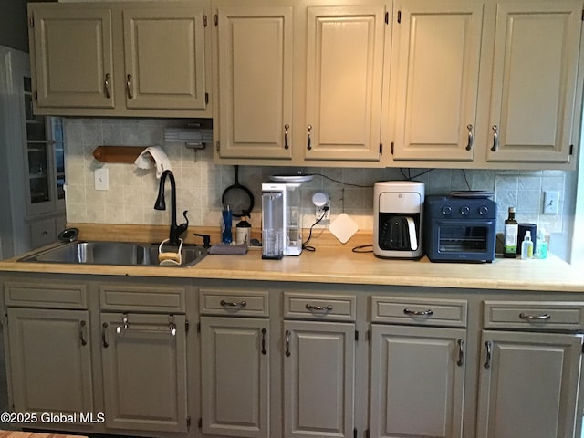 281 10th St, Troy, NY 12180 - kitchen featuring gray cabinetry, a sink, and light countertops