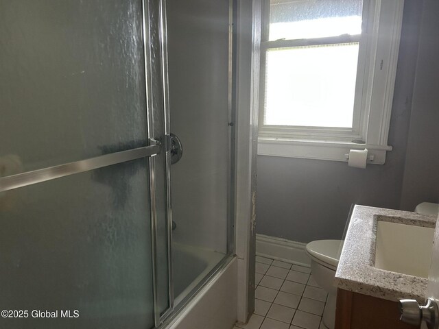 281 10th St, Troy, NY 12180 - bathroom with tile patterned floors, toilet, vanity, bath / shower combo with glass door, and baseboards