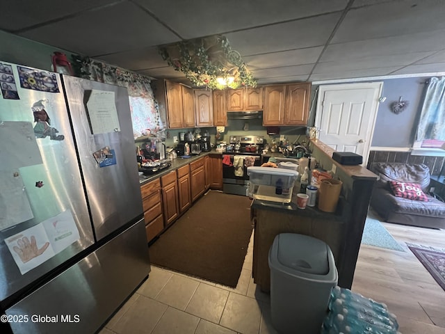 14 Lower Turnpike Rd, Granville, NY 12832 - kitchen with stainless steel appliances, brown cabinets, range hood, a paneled ceiling, and light tile patterned floors